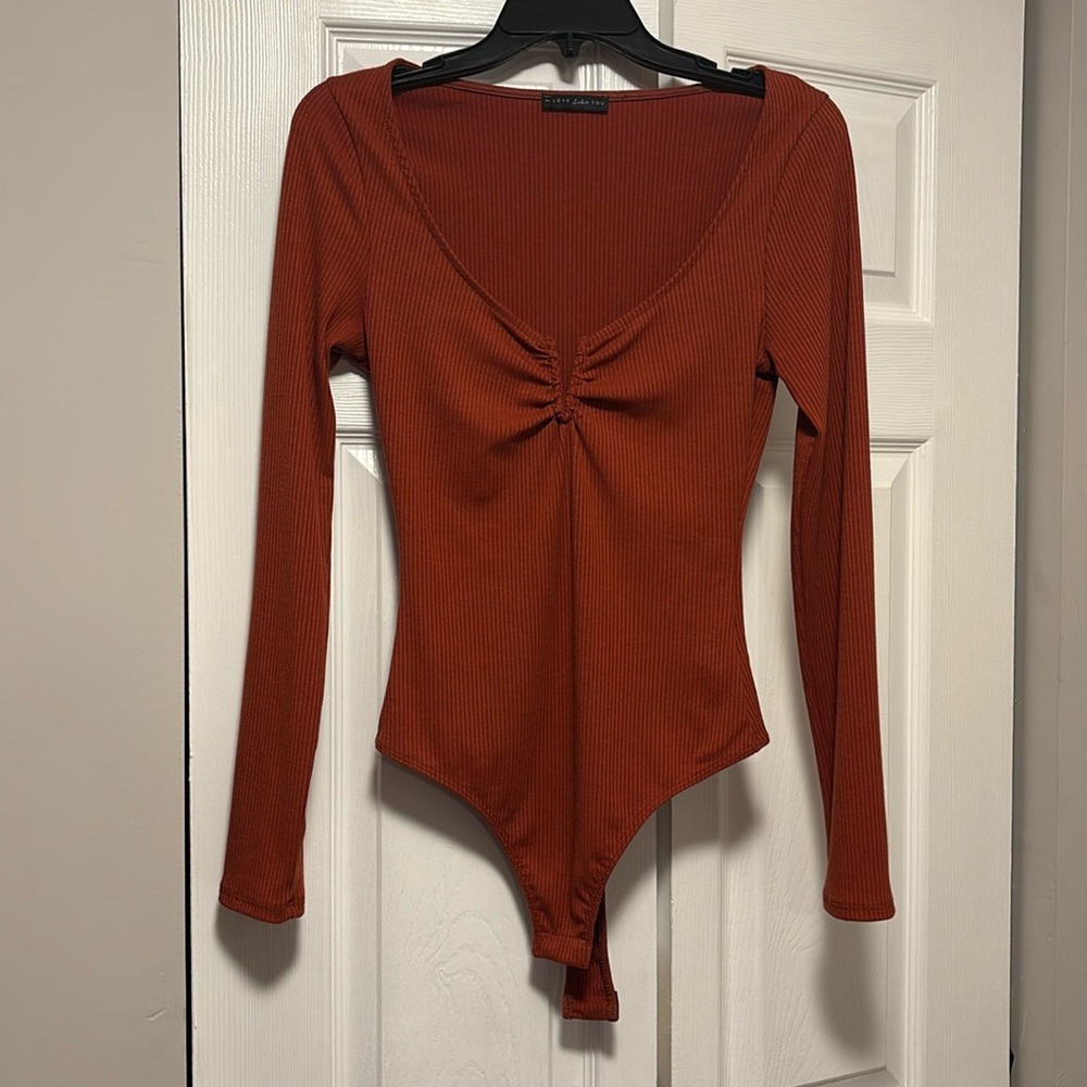 Brand New a LOVE like YOU reddish orange ribbed bodysuit. Small. Never worn.